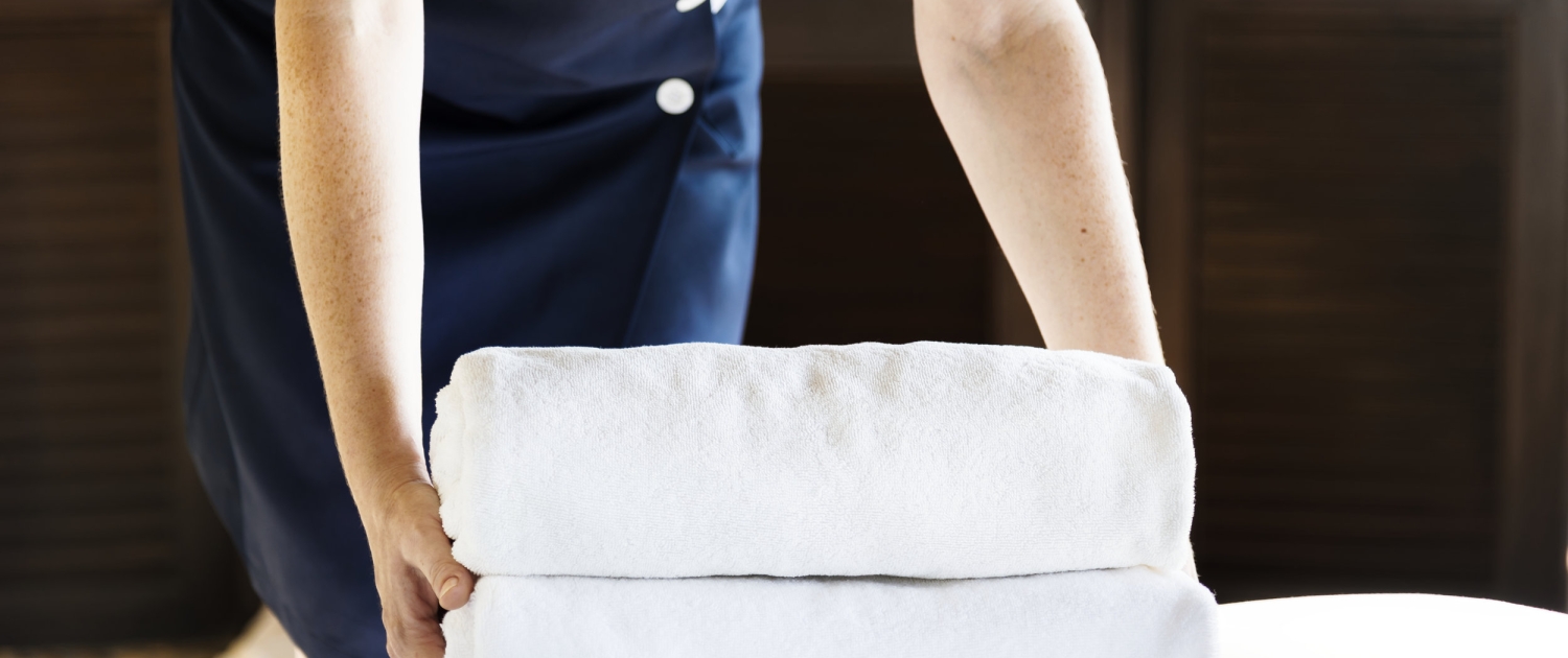 Housekeeper cleaning a hotel room